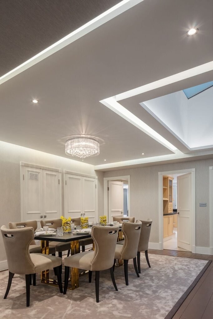 Dining room with cove lighting and rooflight, Porchester Terrace renovation by Elite Contracting Group.